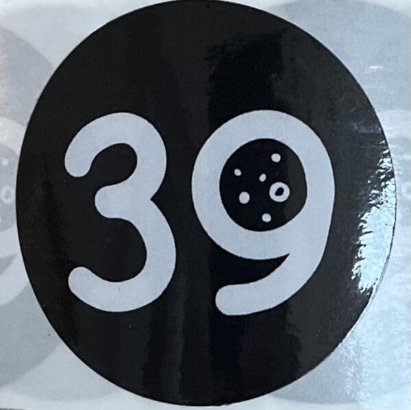 A black and white sticker with the number 3 9.